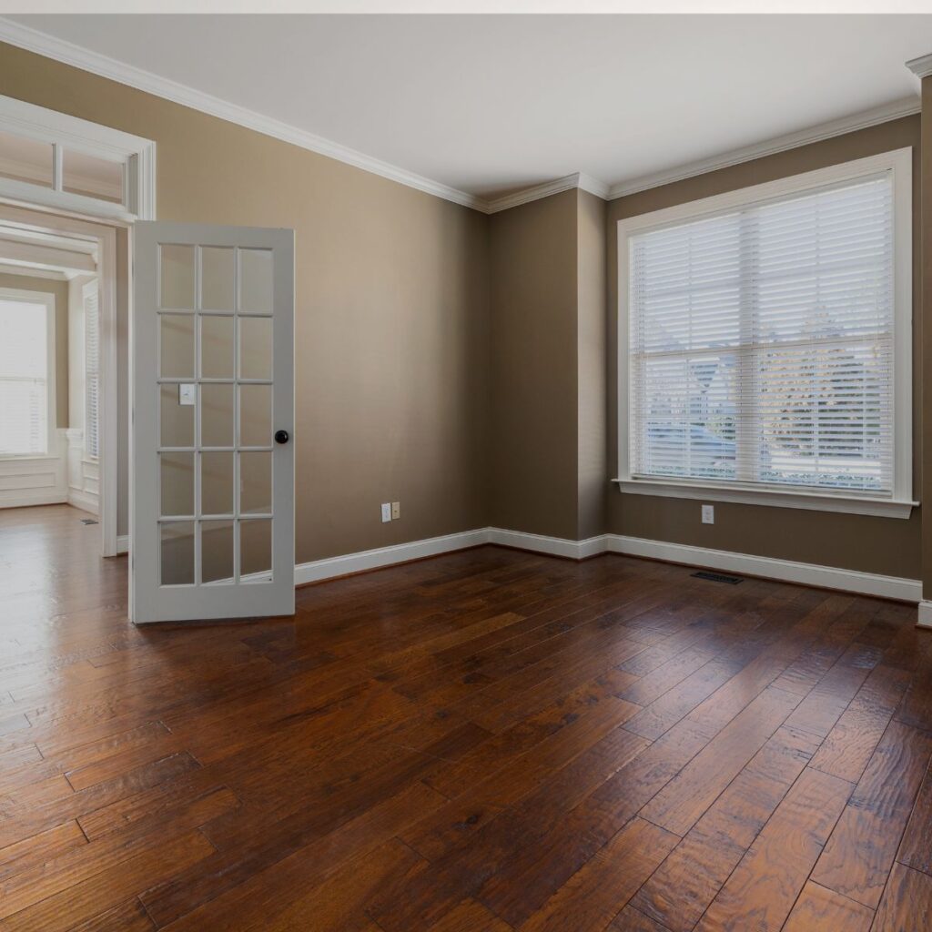 Bright residential room with rich wood-look flooring, ideal inspiration for epoxy flooring Bradenton FL home projects.