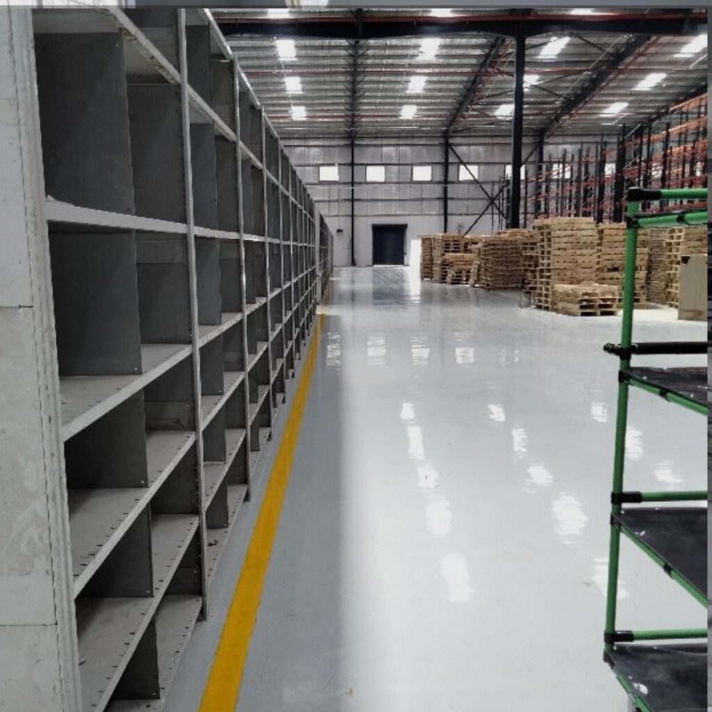 Commercial warehouse featuring durable Epoxy Flooring North Port FL with a smooth, high-gloss finish.