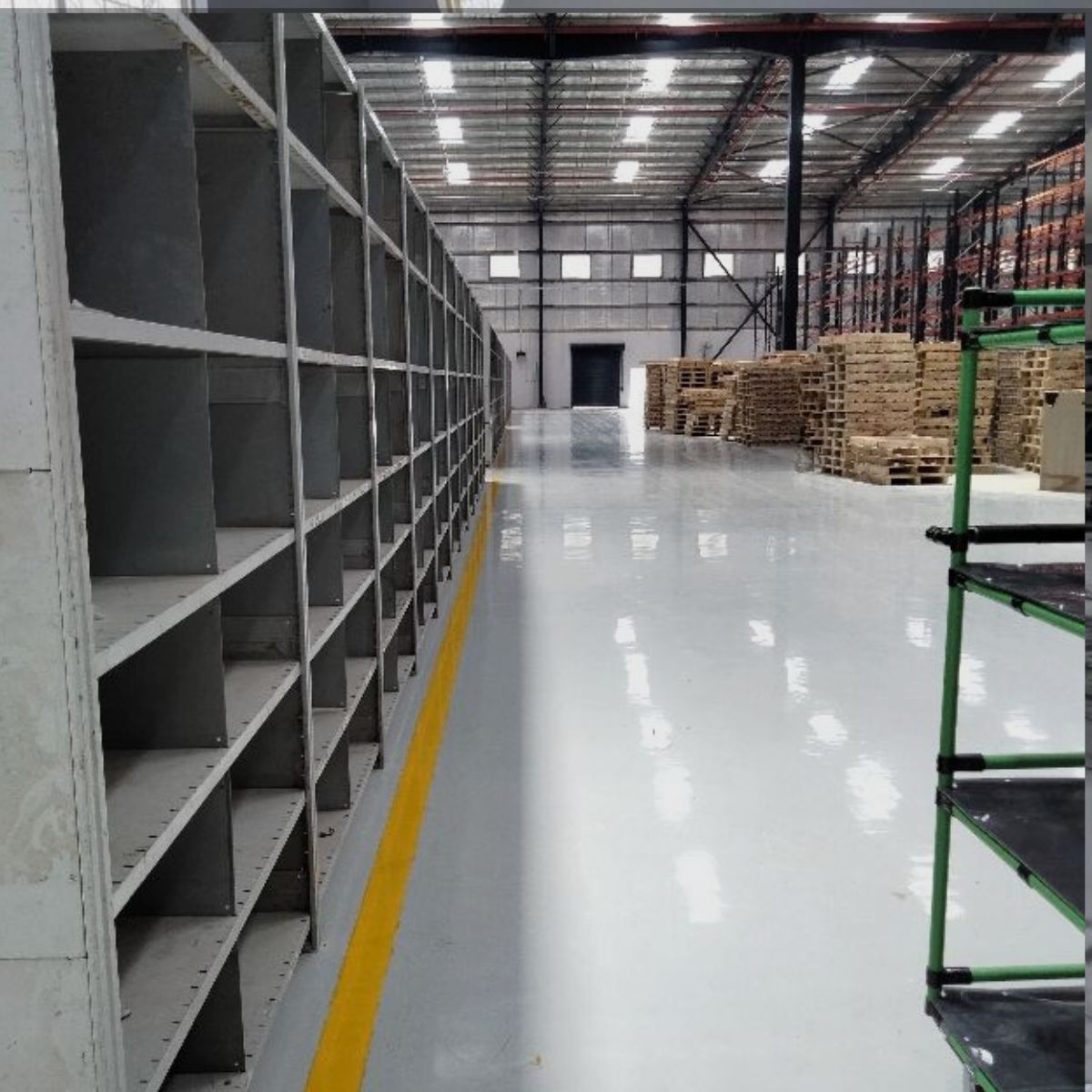 Commercial warehouse featuring durable Epoxy Flooring North Port FL with a smooth, high-gloss finish.