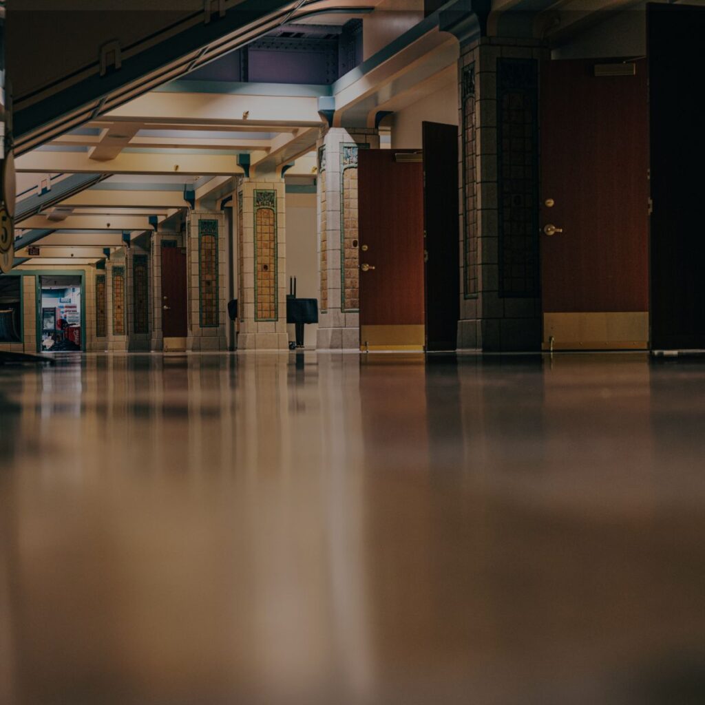 Polished commercial epoxy flooring in Bradenton, FL, creating a durable, seamless surface in a modern interior hallway.
