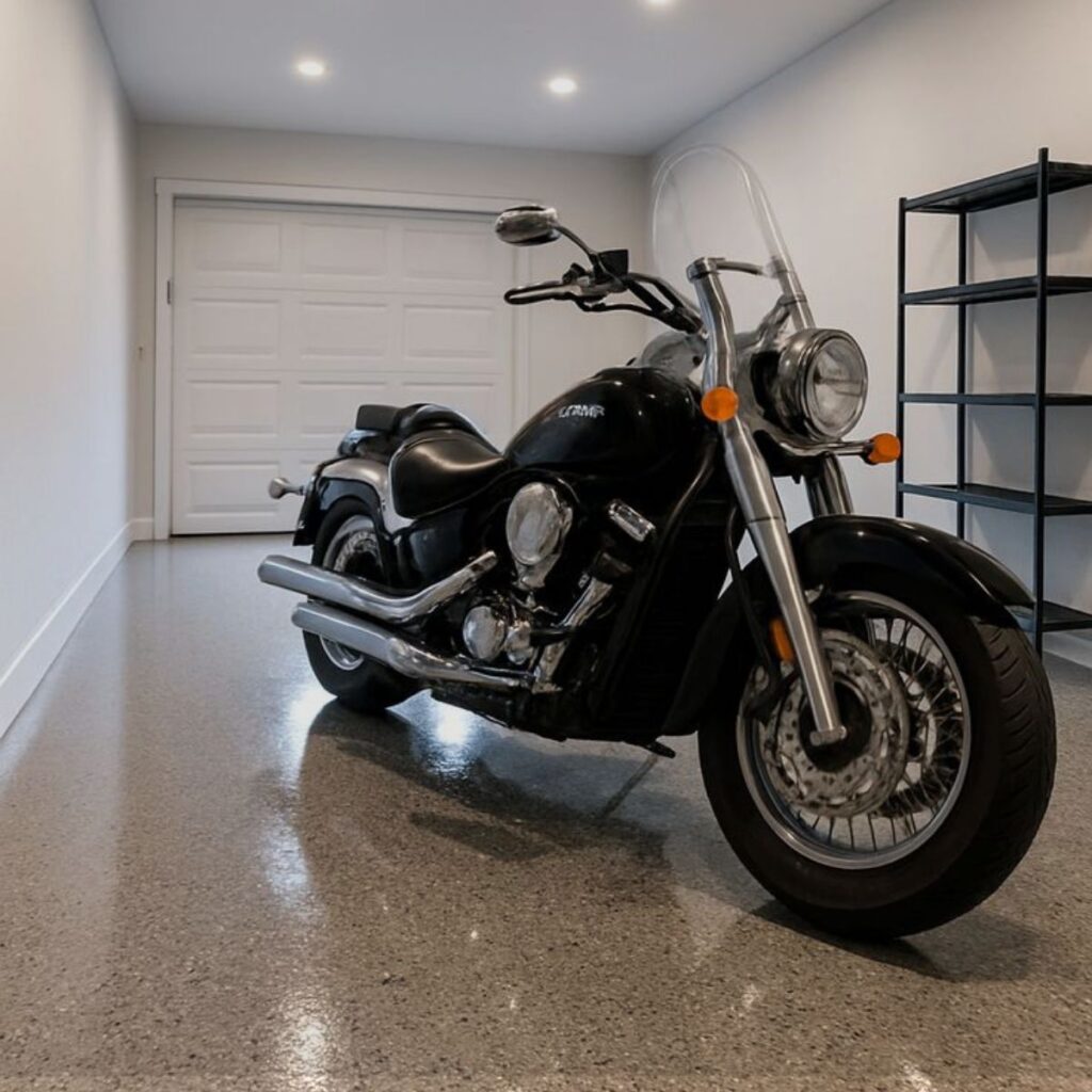 Black motorcycle parked on a durable garage epoxy floor, showcasing professional Epoxy Flooring Sarasota FL.