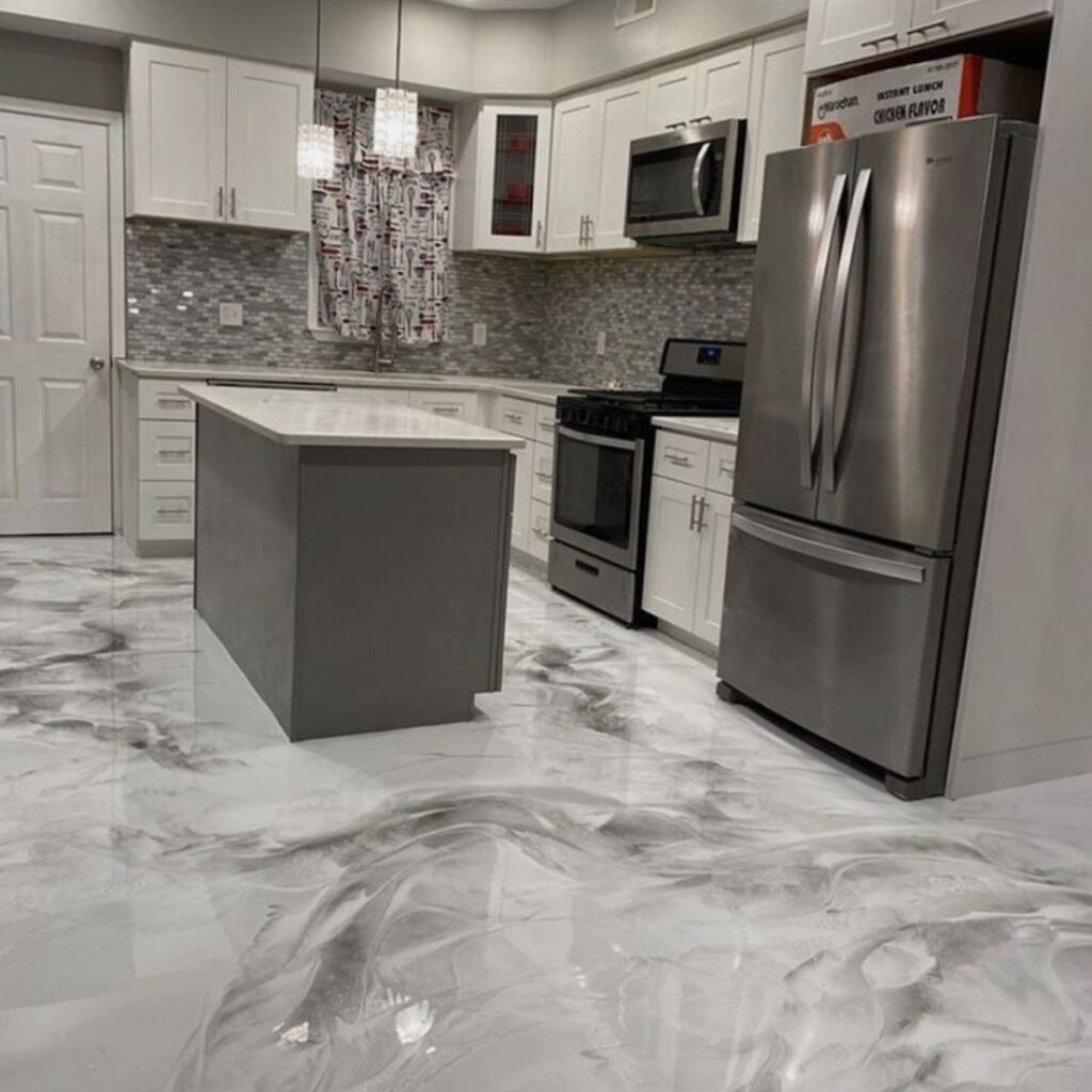 Modern kitchen with a glossy metallic epoxy floor and island countertop, showcasing Epoxy Flooring Sarasota FL.